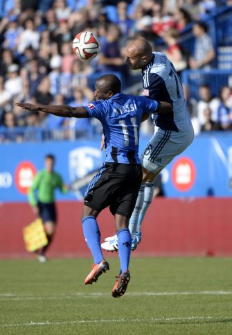 May 10, 2014; Montreal, Quebec, CAN; Head ball between Montreal Impact midfielder Sanna Nyassi (11) and Sporting KC defender Aurelien Collin (78) during the second half at Stade Saputo. Mandatory Credit: Eric Bolte-USA TODAY Sports