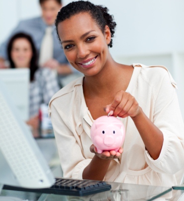 image Smiling businesswoman saving money in a piggy-bank