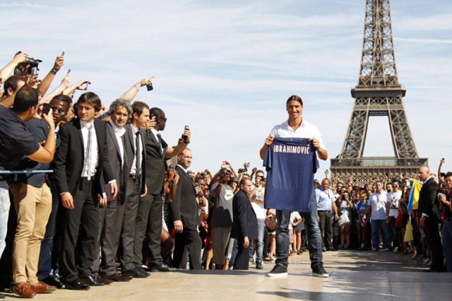 Zlatan Ibrahimovic of Sweden, newly-signed player for French soccer club Paris St Germain, holds his new jersey as he poses at Trocadero square in front of the Eiffel Tower in Paris