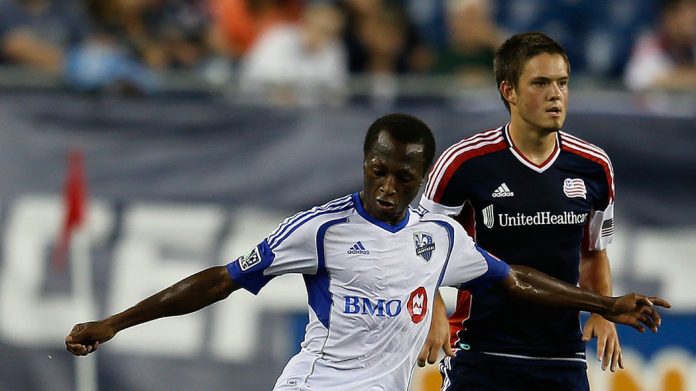 FOXBORO, MA - AUGUST 12: Sanna Nyassi #11 of the Montreal Impact works his way around Kelyn Rowe #11 of the New England Revolution at Gillette Stadium on August 12, 2012 in Foxboro, Massachusetts. (Photo by Jim Rogash/Getty Images)
